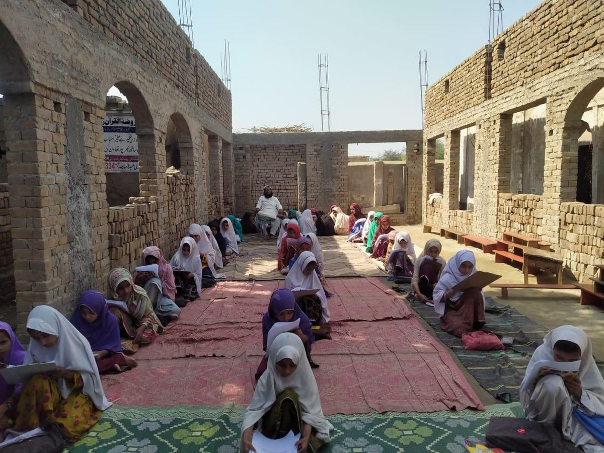 Girls seated in the mosque courtyard